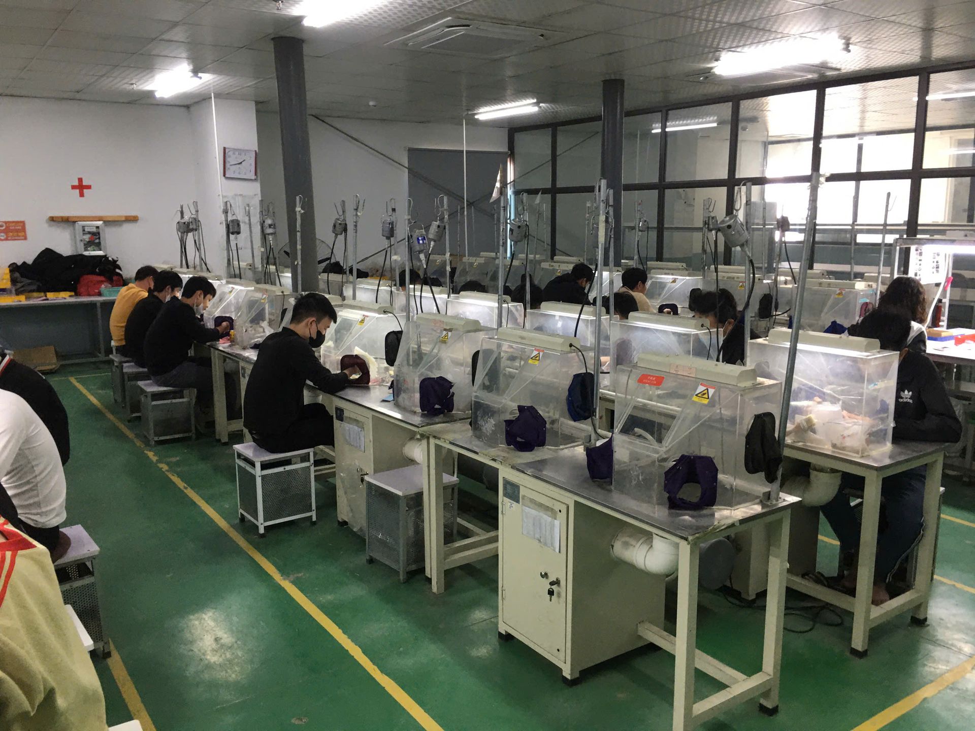 Jinyi Jewelry Factory Vietnam: Artisans at Work in Modern Production Facility | Jewelry Manufacturing Inside the modern Jinyi jewelry factory in Vietnam, skilled artisans engage in detailed jewelry production, hand-polishing custom pieces at specialized workstations.