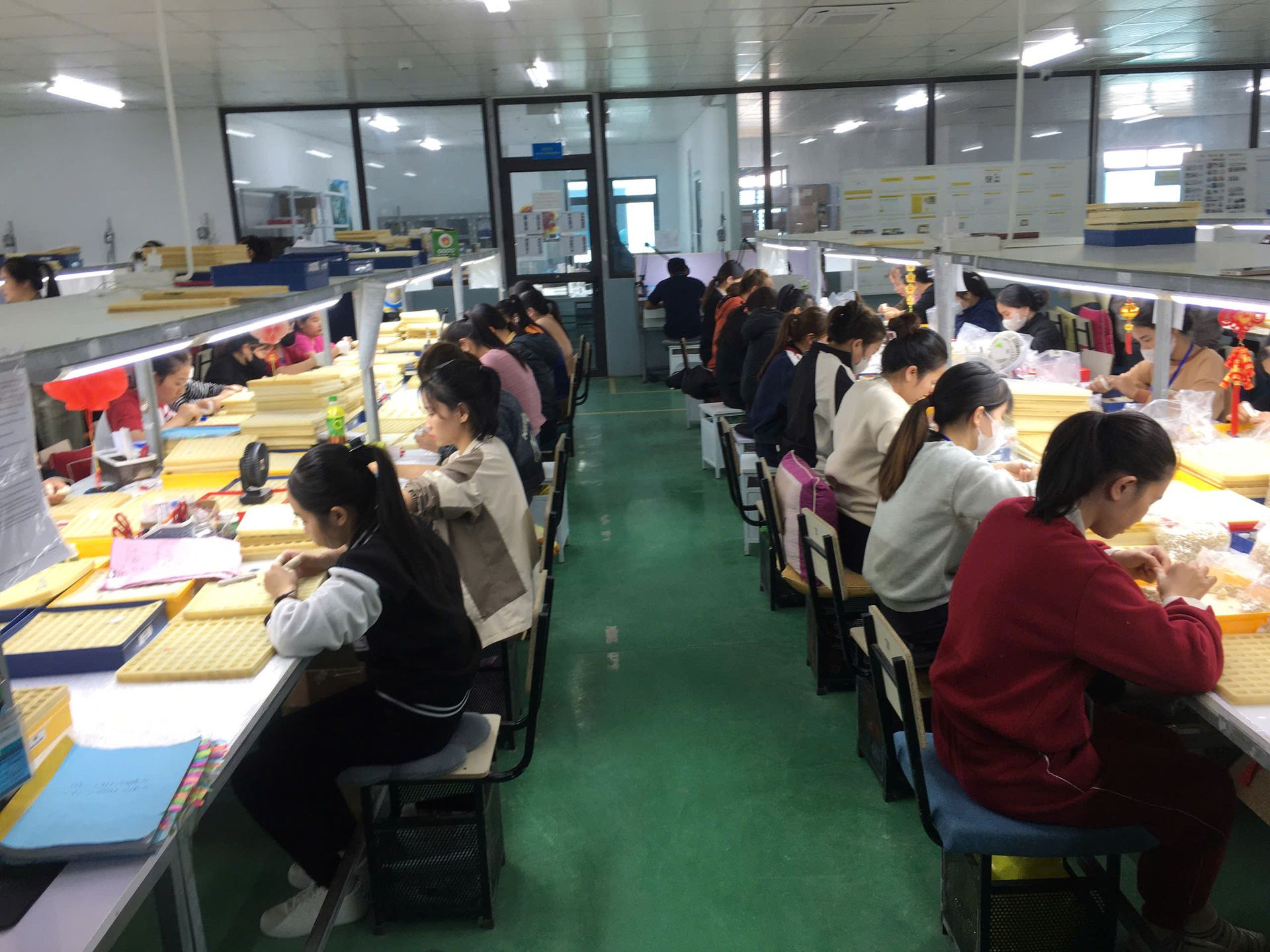 Jinyi Jewelry Factory Vietnam: Artisans at Work in Modern Production Facility | Jewelry Manufacturing Inside the modern Jinyi jewelry factory in Vietnam, skilled artisans engage in detailed jewelry production, hand-polishing custom pieces at specialized workstations.