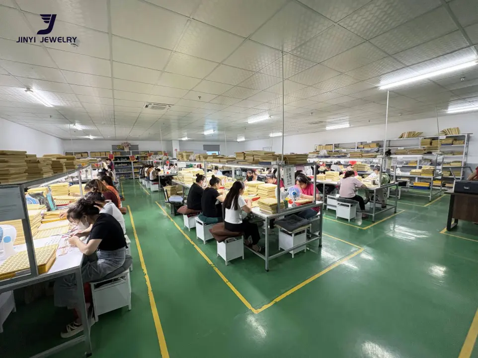 Skilled workers at JINYI JEWELRY production lines, ensuring high-quality OEM and ODM jewelry assembly.