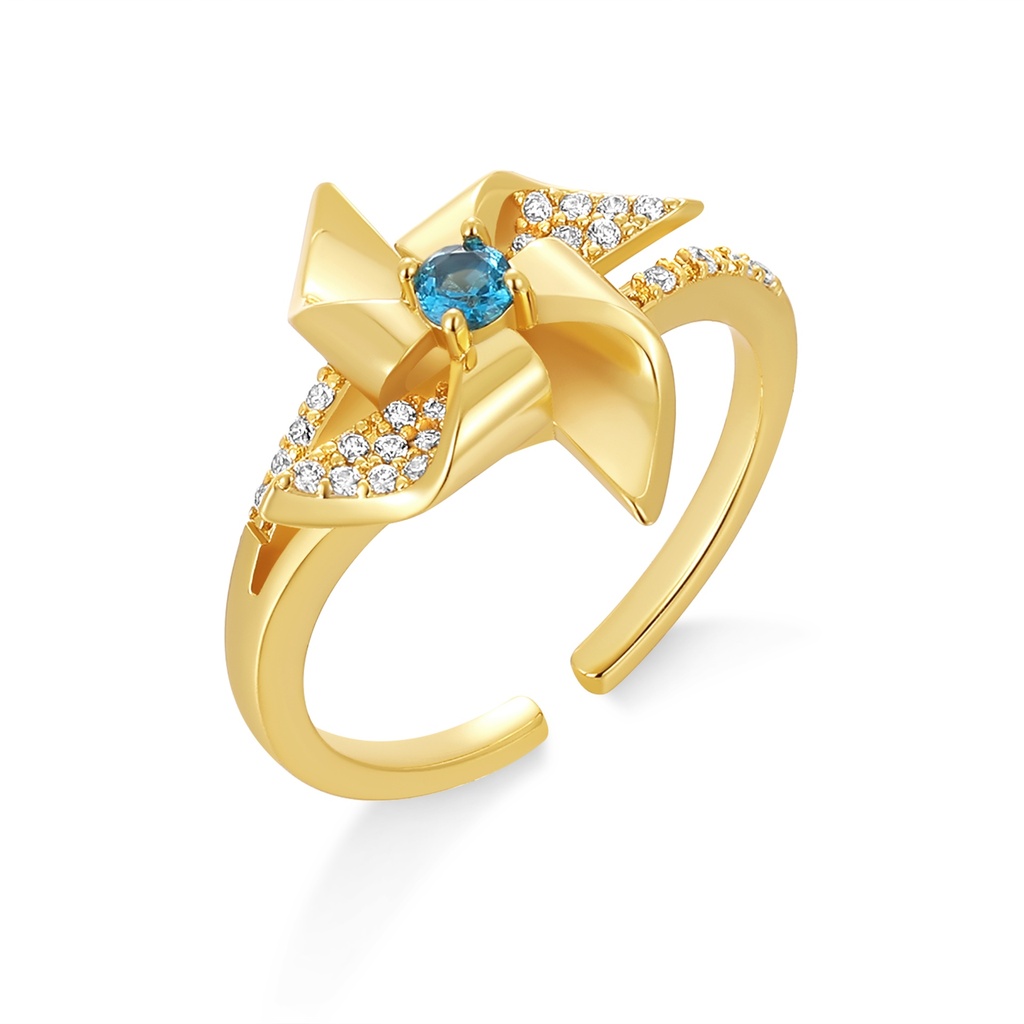 Gold Pinwheel Design Ring with Sparkling Blue Center Stone